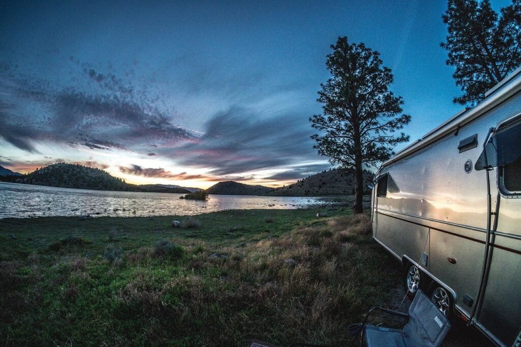 RV by a lake at sunset
